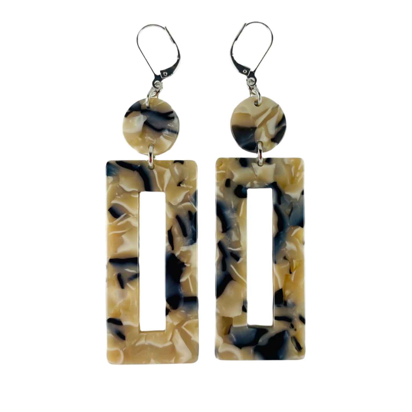 Dangling earring with two geometric shaped beads. One dime shaped and one donut shaped rectangle. Marbled beige, midnight blue and white.