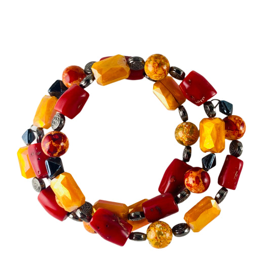 Bracelet with orange, red glass beads accented with gunmetal colored metal beads.  Strung on memory wire.